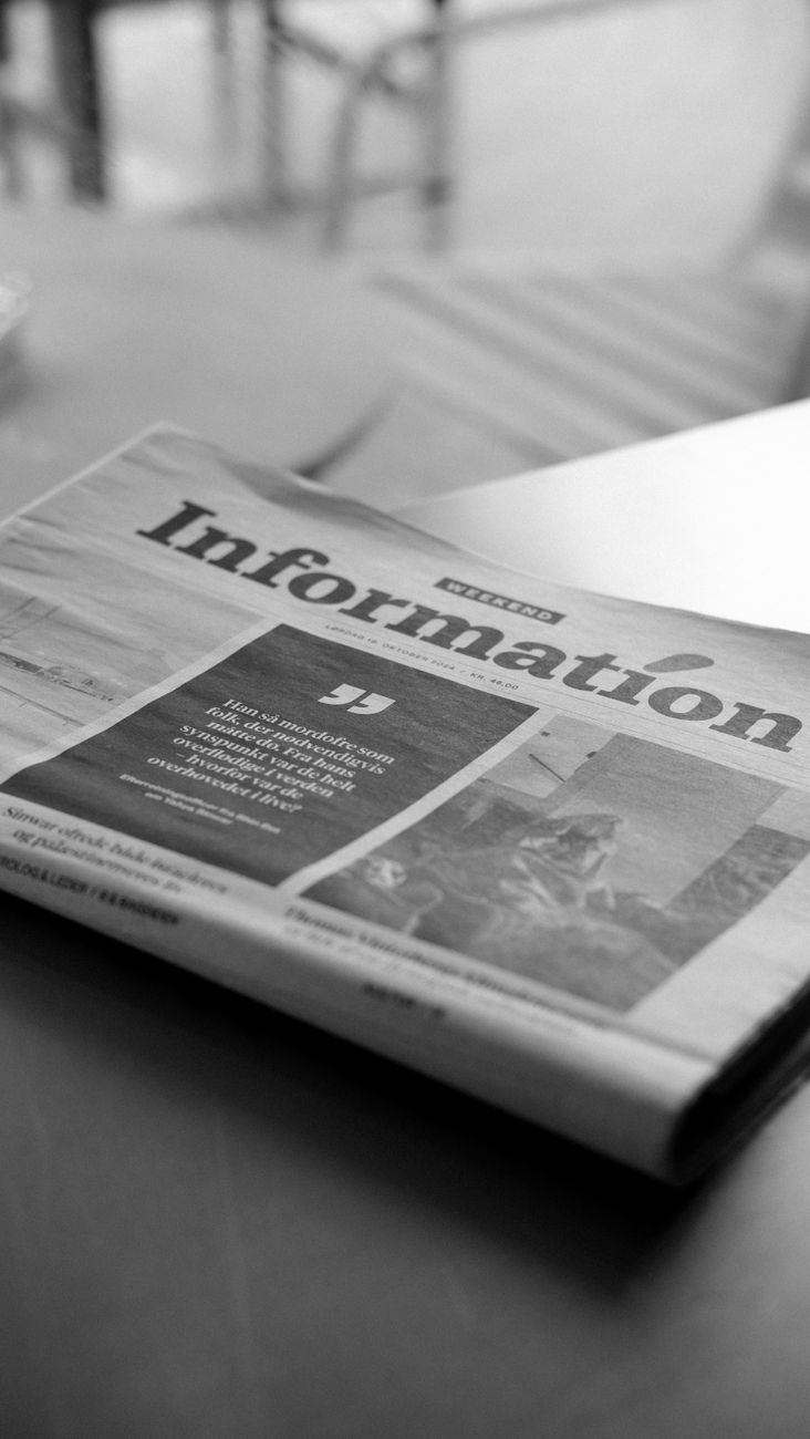 black and white newspaper on a table in cafe