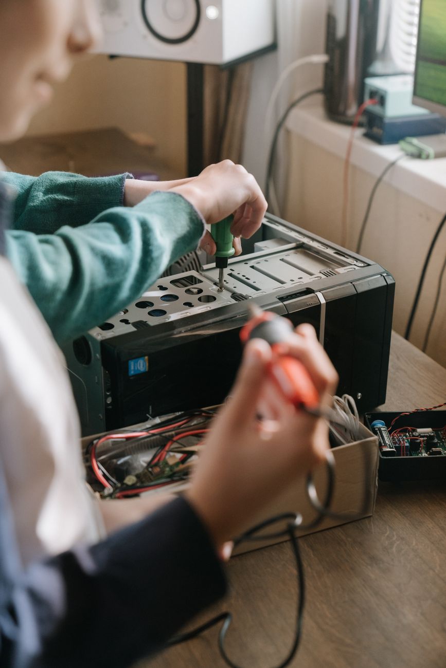 person in green sweater playing audio mixer